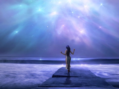 Woman on a pier surrounded by bright lights